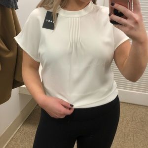 White blouse with tags. Brand: DKNY.